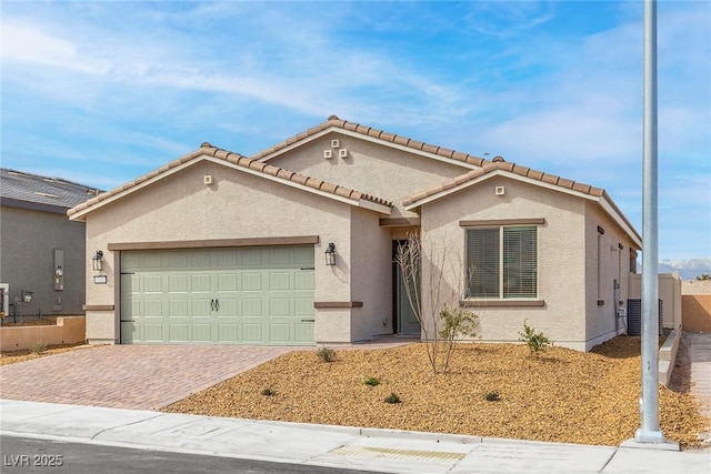 2751 Avril Point St, Las Vegas, NV 89156 - mediterranean / spanish home with stucco siding, a garage, decorative driveway, and a tile roof