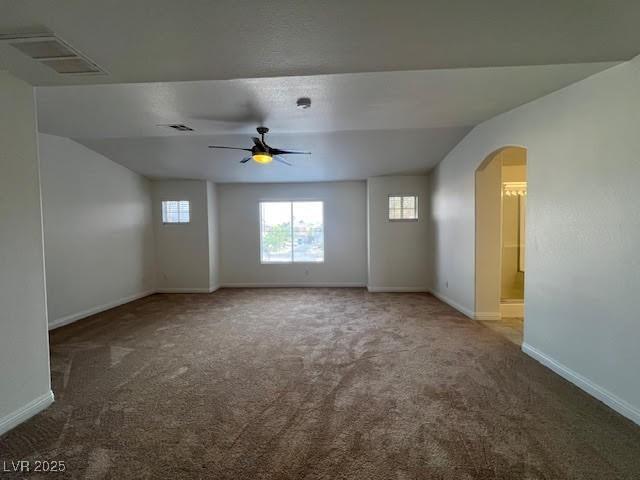 1030 Country Skies Ave, Las Vegas, NV 89123 - empty room with carpet flooring, a ceiling fan, arched walkways, baseboards, and vaulted ceiling