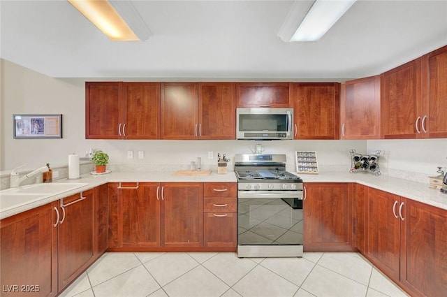 150 Las Vegas Blvd Unit 1503, Las Vegas, NV 89101 - kitchen with stainless steel appliances, light countertops, light tile patterned flooring, and a sink