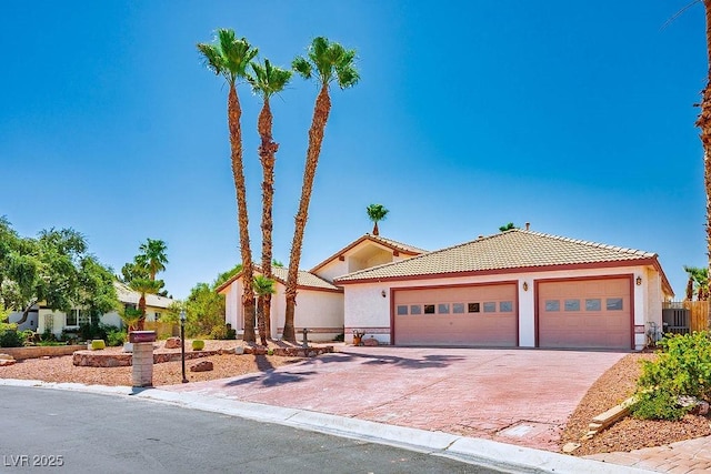 5401 Indian Hills Ave, Las Vegas, NV 89130 - view of front of home with a tiled roof, stucco siding, driveway, and an attached garage