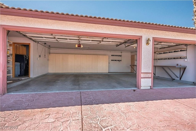 5401 Indian Hills Ave, Las Vegas, NV 89130 - garage featuring a garage door opener and black fridge