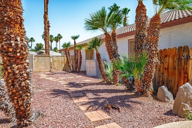 5401 Indian Hills Ave, Las Vegas, NV 89130 - view of side of home with a gate, stucco siding, and a tiled roof