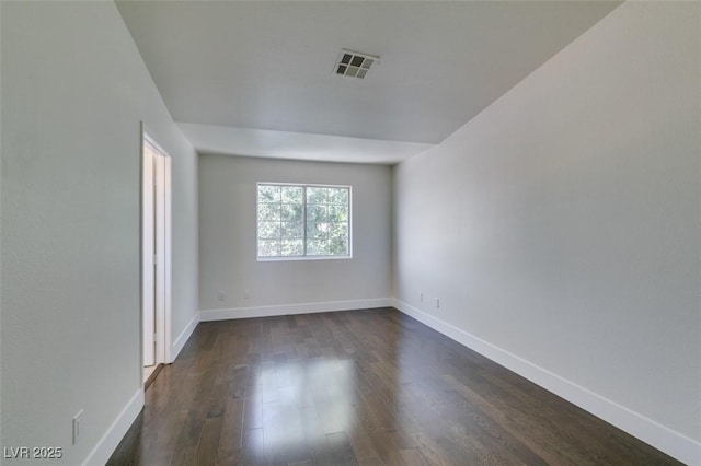 5330 E Charleston Blvd Unit 2, Las Vegas, NV 89142 - unfurnished room with dark wood-style flooring and baseboards