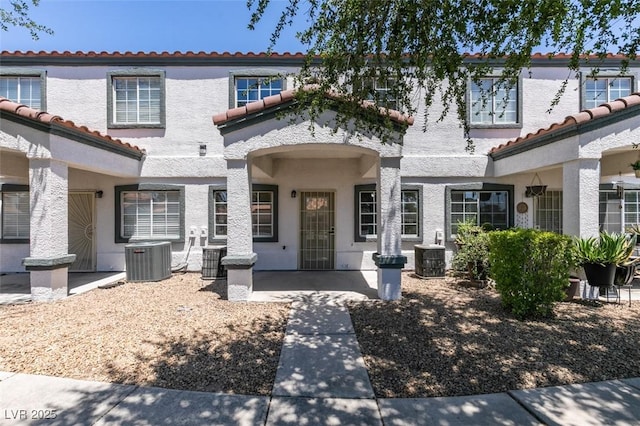 5330 E Charleston Blvd Unit 2, Las Vegas, NV 89142 - view of front facade with central AC unit, a tile roof, and stucco siding