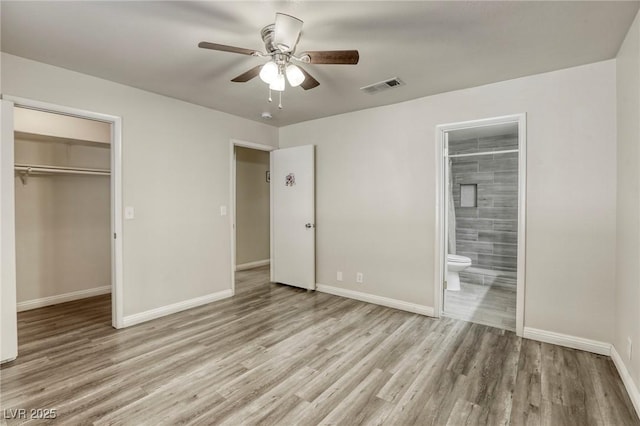5132 Springland St, Las Vegas, NV 89146 - unfurnished bedroom featuring wood finished floors, baseboards, a closet, a spacious closet, and ensuite bath