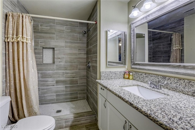 5132 Springland St, Las Vegas, NV 89146 - bathroom with toilet, vanity, and tiled shower