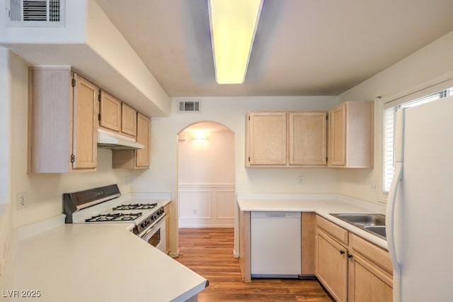 698 S Racetrack Rd Unit 1014, Henderson, NV 89015 - kitchen featuring white appliances, light brown cabinets, under cabinet range hood, arched walkways, and dark wood-style flooring