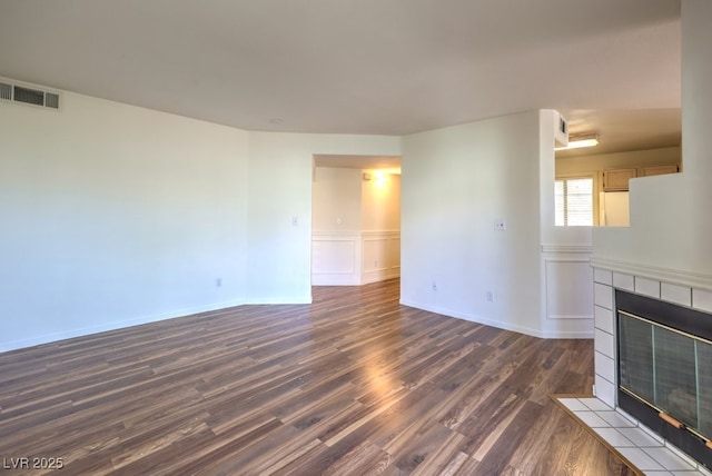 698 S Racetrack Rd Unit 1014, Henderson, NV 89015 - unfurnished living room with a tile fireplace, dark wood-style floors, and baseboards