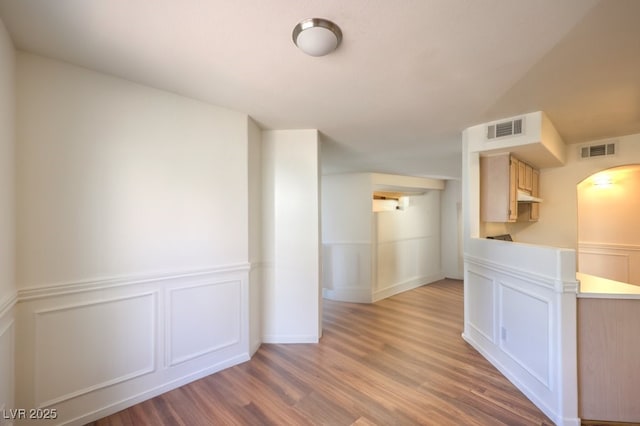 698 S Racetrack Rd Unit 1014, Henderson, NV 89015 - spare room featuring wood finished floors, a decorative wall, and a wainscoted wall