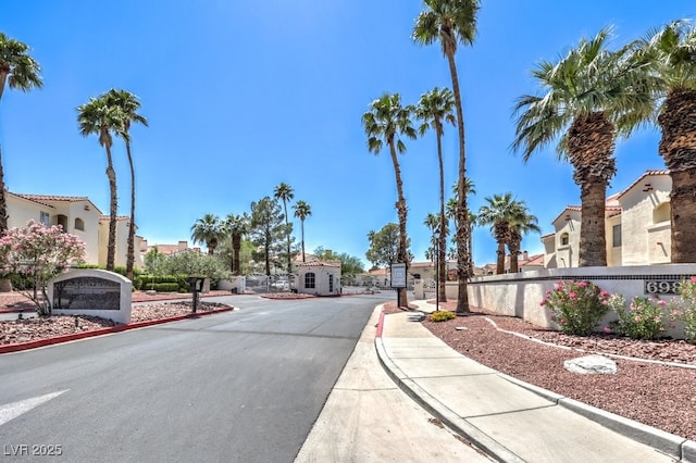 698 S Racetrack Rd Unit 1014, Henderson, NV 89015 - view of asphalt road with curbs, a residential view, sidewalks, and a gated entry