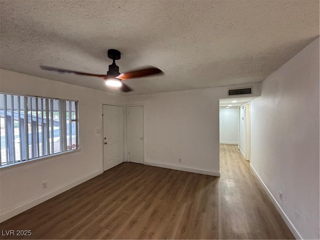 5920 Glen Eagles Ln, Las Vegas, NV 89108 - spare room featuring a textured ceiling, wood finished floors, ceiling fan, and baseboards