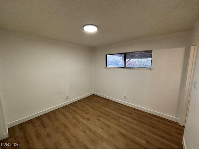 5920 Glen Eagles Ln, Las Vegas, NV 89108 - unfurnished room with wood finished floors, baseboards, and a textured ceiling