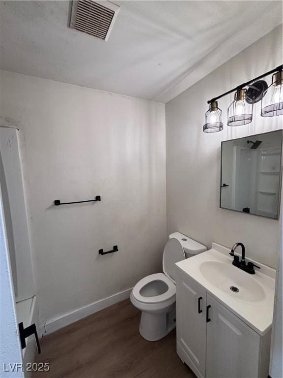 5920 Glen Eagles Ln, Las Vegas, NV 89108 - bathroom with wood finished floors, toilet, vanity, and baseboards