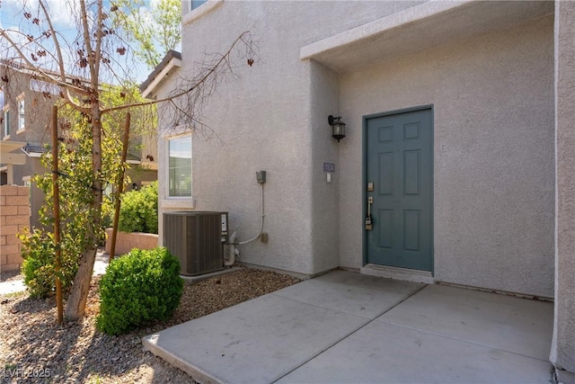 4566 Mansart Ct Unit 1104, North Las Vegas, NV 89031 - view of exterior entry featuring central AC unit and stucco siding