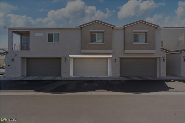 4566 Mansart Ct Unit 1104, North Las Vegas, NV 89031 - view of property with stucco siding and an attached garage