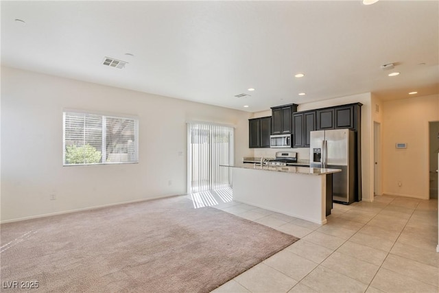 4566 Mansart Ct Unit 1104, North Las Vegas, NV 89031 - kitchen featuring appliances with stainless steel finishes, dark cabinetry, recessed lighting, light tile patterned floors, and open floor plan