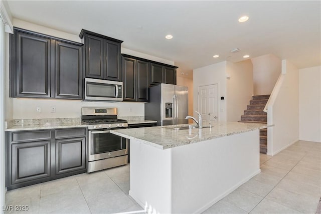 4566 Mansart Ct Unit 1104, North Las Vegas, NV 89031 - kitchen featuring appliances with stainless steel finishes, a sink, light tile patterned floors, a center island with sink, and recessed lighting