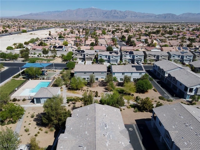 4566 Mansart Ct Unit 1104, North Las Vegas, NV 89031 - aerial perspective of suburban area with a pool area and a mountain backdrop