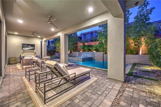 10 Sugarberry Ln, Las Vegas, NV 89135 - fenced backyard with ceiling fan, an outdoor hangout area, a patio area, and a pool with connected hot tub