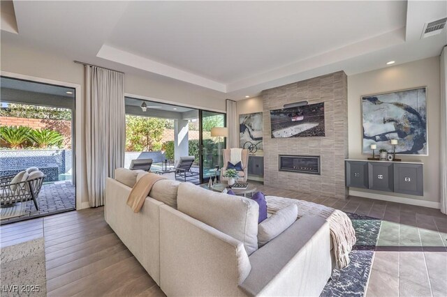 10 Sugarberry Ln, Las Vegas, NV 89135 - living room with a tray ceiling, a fireplace, and recessed lighting