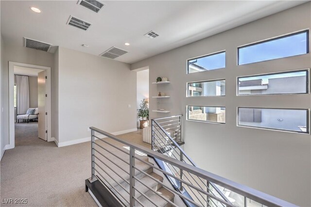 10 Sugarberry Ln, Las Vegas, NV 89135 - hallway with an upstairs landing, light carpet, recessed lighting, and baseboards