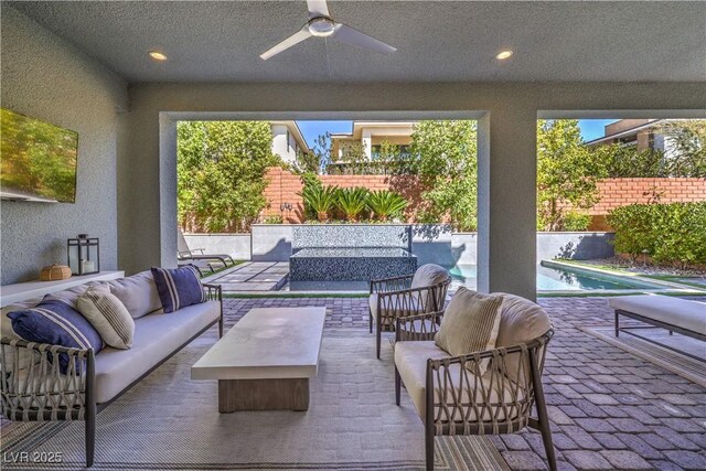 10 Sugarberry Ln, Las Vegas, NV 89135 - fenced backyard with an outdoor hangout area, ceiling fan, and a patio
