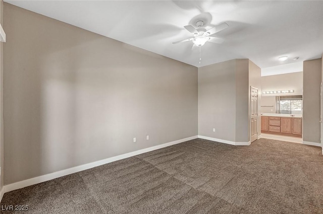 9303 Gilcrease Ave Unit 2217, Las Vegas, NV 89149 - unfurnished room with ceiling fan, dark colored carpet, and baseboards