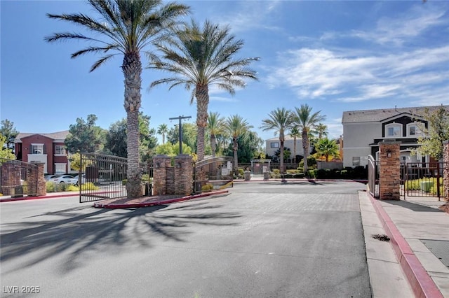9303 Gilcrease Ave Unit 2217, Las Vegas, NV 89149 - view of asphalt street featuring a gate, curbs, a gated entry, and sidewalks