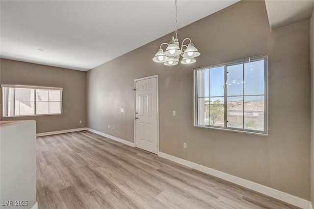 9303 Gilcrease Ave Unit 2217, Las Vegas, NV 89149 - unfurnished room featuring a chandelier, light wood-type flooring, and baseboards