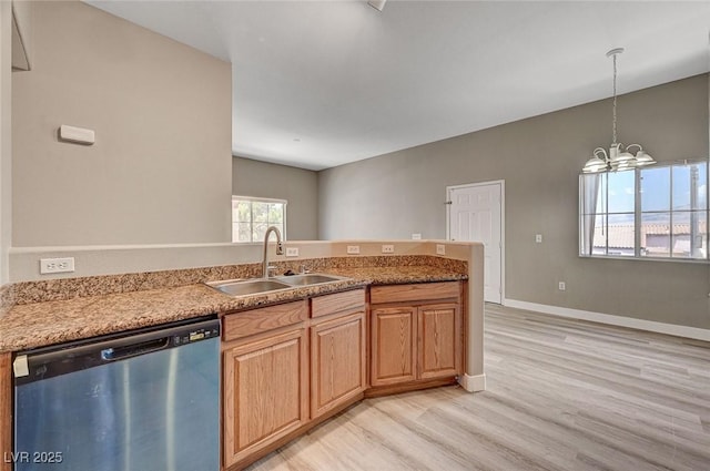 9303 Gilcrease Ave Unit 2217, Las Vegas, NV 89149 - kitchen featuring dishwasher, a sink, light wood-type flooring, a chandelier, and a peninsula