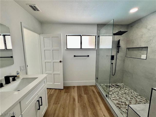 6191 Bullion Blvd, Las Vegas, NV 89103 - full bath featuring a tile shower, wood finished floors, vanity, and baseboards