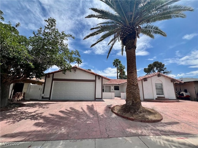 6191 Bullion Blvd, Las Vegas, NV 89103 - view of front of house with decorative driveway, a garage, stucco siding, and a tile roof