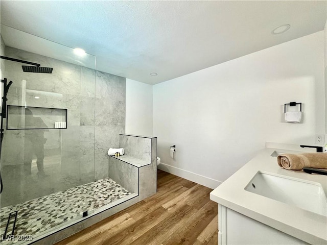 6191 Bullion Blvd, Las Vegas, NV 89103 - full bath featuring tiled shower, double vanity, wood finished floors, baseboards, and toilet