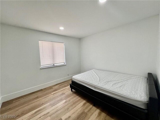 6191 Bullion Blvd, Las Vegas, NV 89103 - bedroom with light wood finished floors, baseboards, and recessed lighting