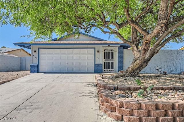 6309 Miraloma St, Las Vegas, NV 89108 - ranch-style home with driveway, a garage, and brick siding