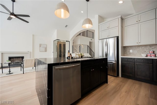 8140 Bay Harbor Dr, Las Vegas, NV 89128 - kitchen featuring appliances with stainless steel finishes, a sink, ceiling fan, decorative backsplash, and open floor plan