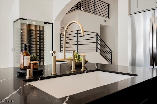 8140 Bay Harbor Dr, Las Vegas, NV 89128 - kitchen view of freestanding refrigerator, arched walkways, stainless steel refrigerator, and a sink