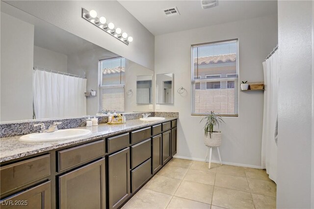 2169 Rio Rancho Pointe Pl, Henderson, NV 89002 - bathroom with double vanity, baseboards, tile patterned floors, and curtained shower