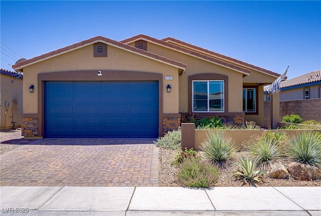 2169 Rio Rancho Pointe Pl, Henderson, NV 89002 - view of front of property featuring stucco siding, an attached garage, decorative driveway, and stone siding