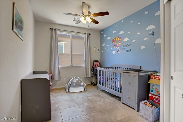 2169 Rio Rancho Pointe Pl, Henderson, NV 89002 - tiled bedroom featuring a nursery area, baseboards, and ceiling fan