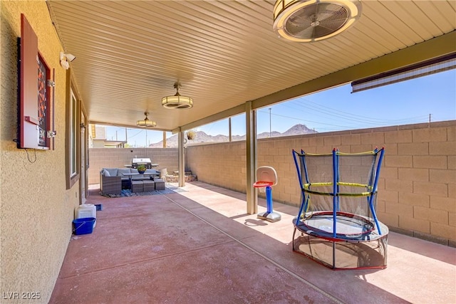 2169 Rio Rancho Pointe Pl, Henderson, NV 89002 - fenced backyard with a patio area, outdoor lounge area, and a mountain view