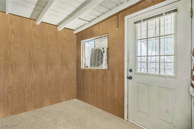 960 Third St, Pahrump, NV 89048 - doorway to outside with wooden walls, beamed ceiling, and carpet floors