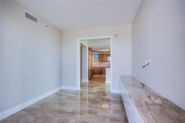 222 Karen Ave Unit 2308, Las Vegas, NV 89109 - bathroom featuring marble tiled floors, decorative backsplash, and baseboards