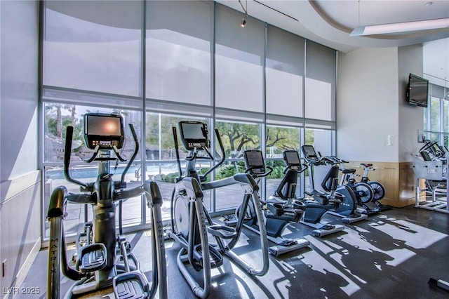 222 Karen Ave Unit 2308, Las Vegas, NV 89109 - exercise room featuring a towering ceiling and a wainscoted wall