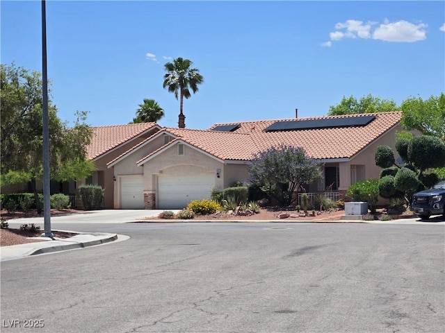 8777 Shady Peak Way, Las Vegas, NV 89123 - view of front of property with stucco siding, a tiled roof, an attached garage, solar panels, and driveway