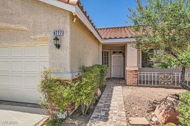8777 Shady Peak Way, Las Vegas, NV 89123 - property entrance featuring stucco siding, a tile roof, and an attached garage