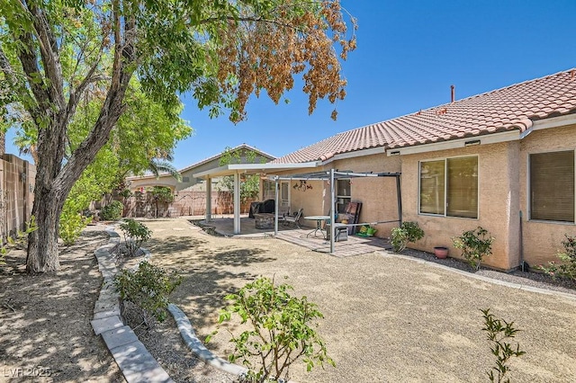 8777 Shady Peak Way, Las Vegas, NV 89123 - rear view of property with a tiled roof, a fenced backyard, stucco siding, and a patio