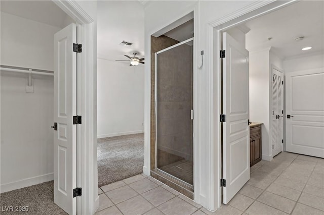 12 Strada Di Circolo -, Unit Henderson, NV 89011 - bathroom featuring a stall shower, a ceiling fan, tile patterned flooring, a walk in closet, and ornamental molding