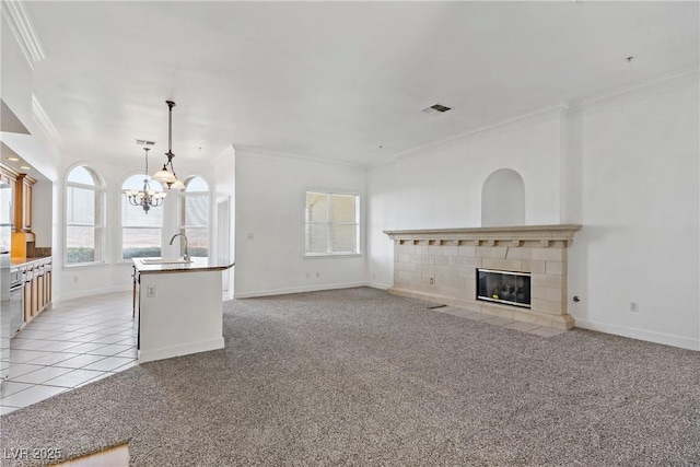 12 Strada Di Circolo -, Unit Henderson, NV 89011 - kitchen featuring crown molding, a chandelier, open floor plan, baseboards, and a sink