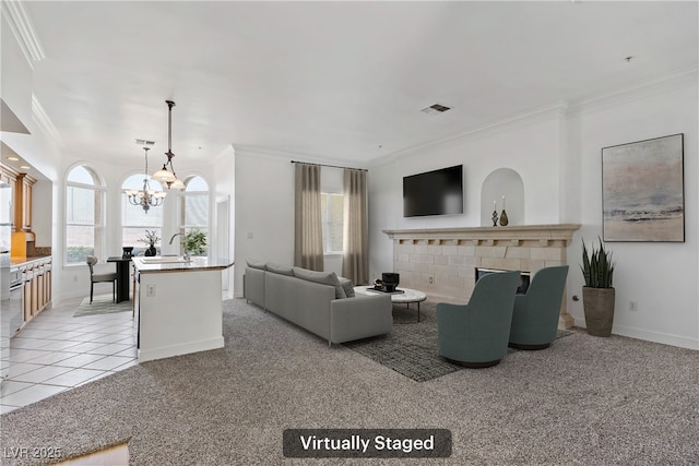 12 Strada Di Circolo -, Unit Henderson, NV 89011 - living area with ornamental molding, a chandelier, light colored carpet, baseboards, and a fireplace